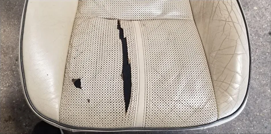 Before: Torn perforated leather
