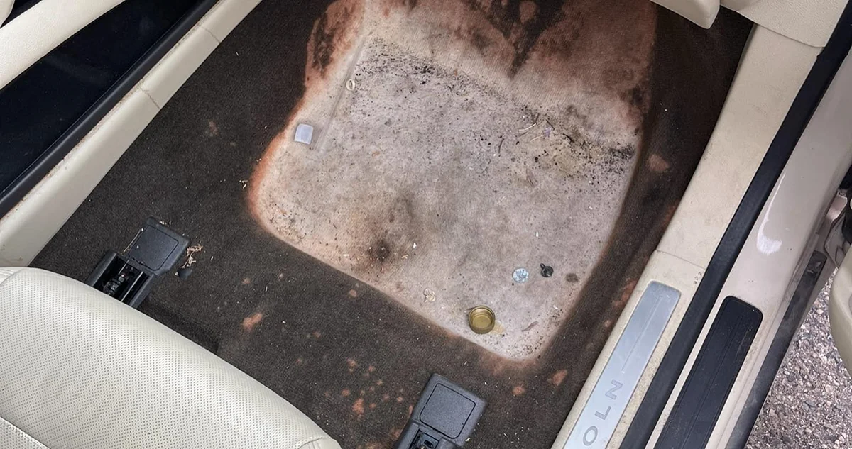 Worn automotive carpet before repair