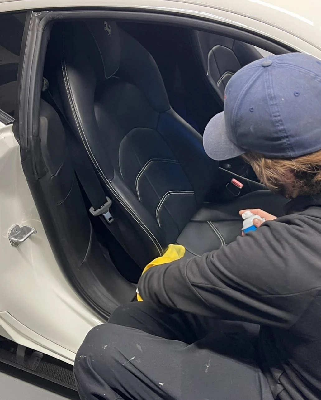 Working on a white Ferrari’s front seats