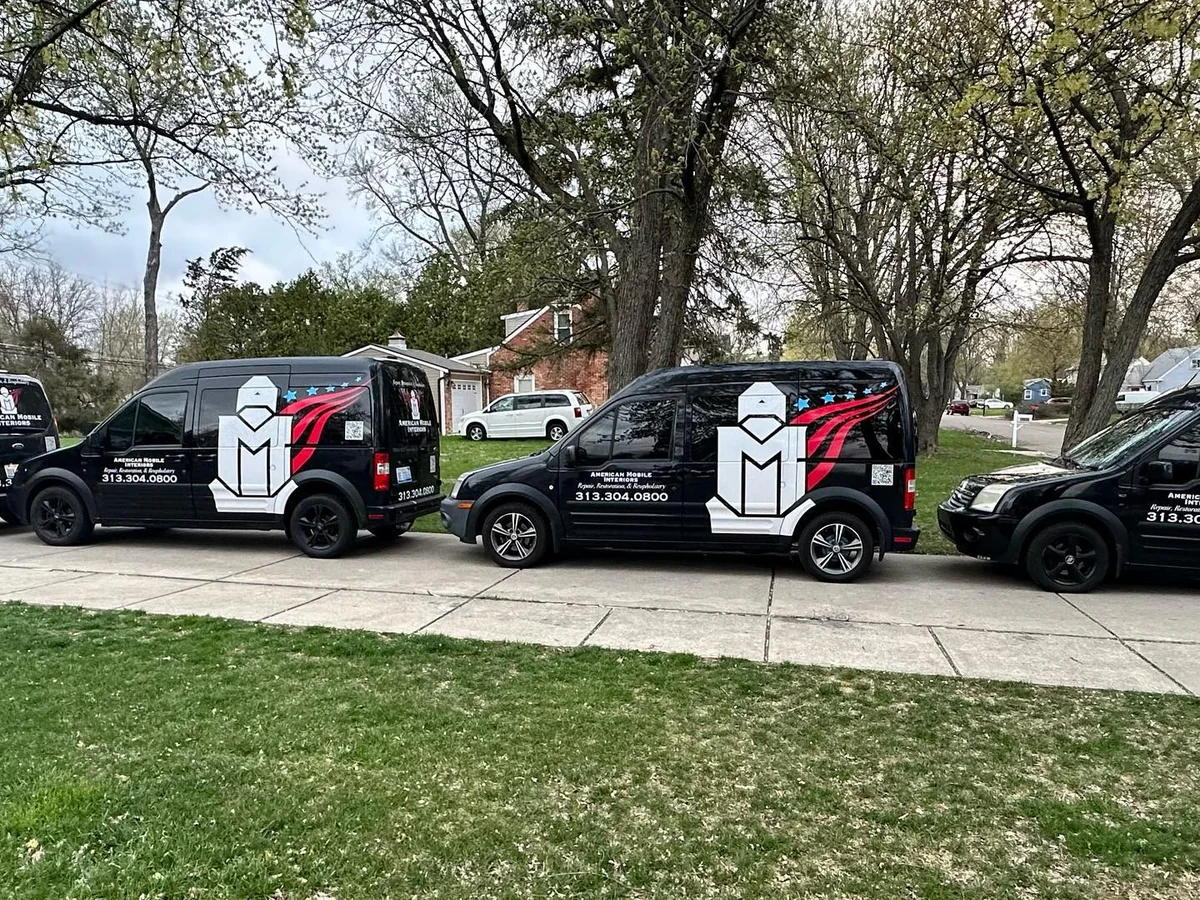 Black American Mobile Interiors service vans parked on a street