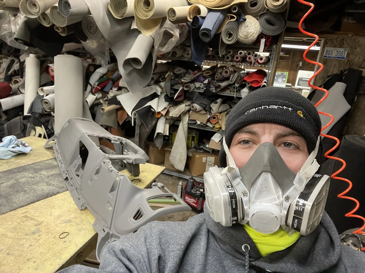Technician surrounded by upholstery materials