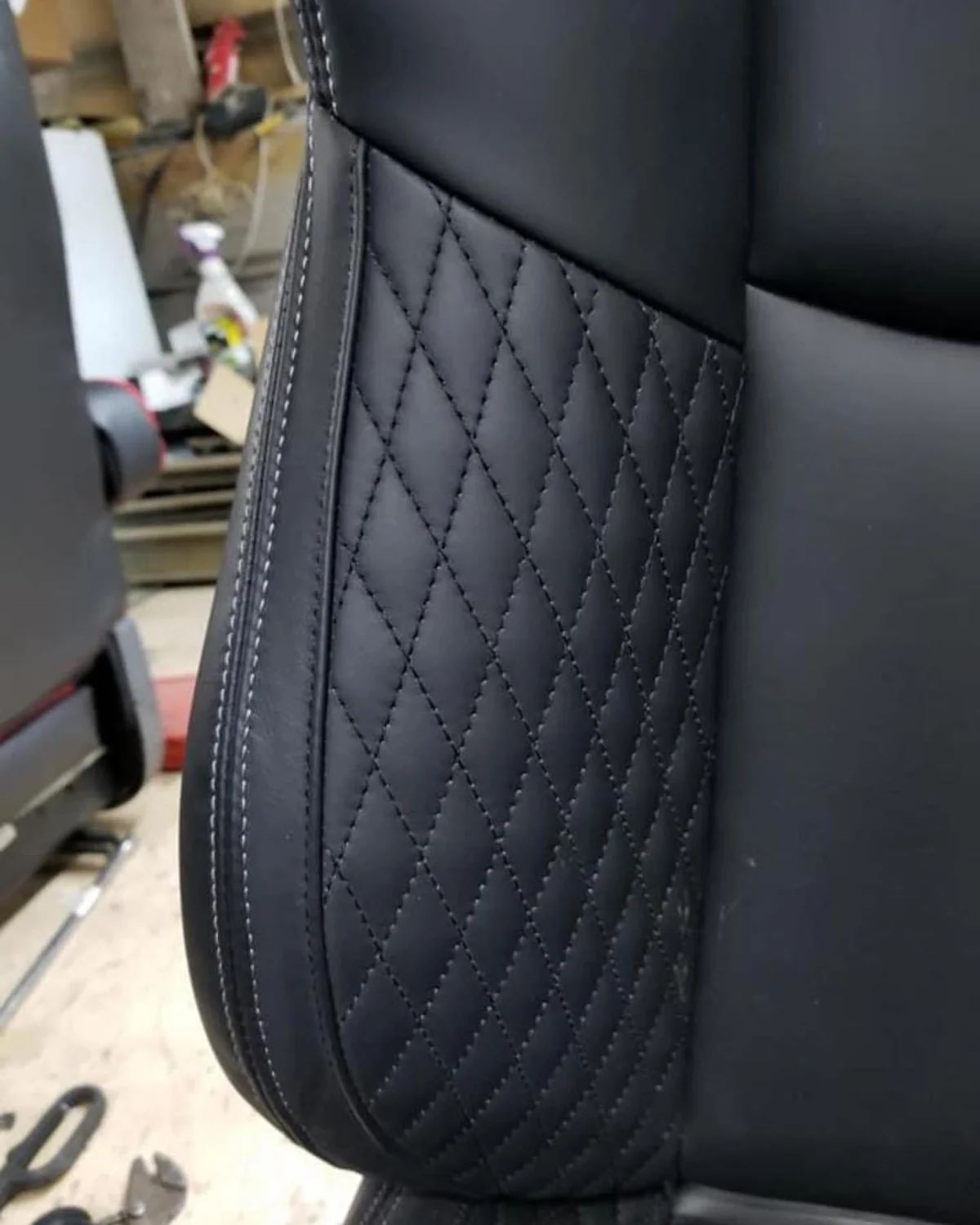 Custom black leather seat with diamond stitching